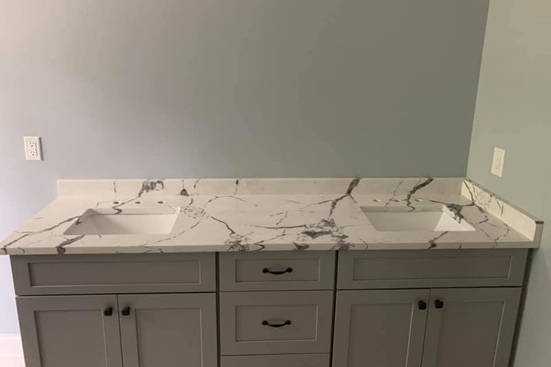 Luxurious marble vanity top featuring porcelain sink in upscale bathroom remodel